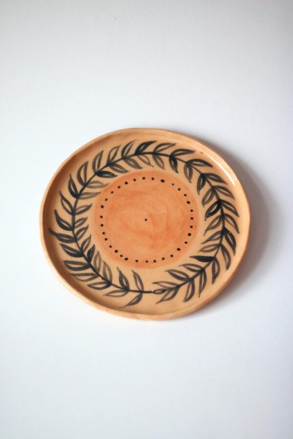 A beautifully crafted ceramic plate featuring a delicate leaf design.